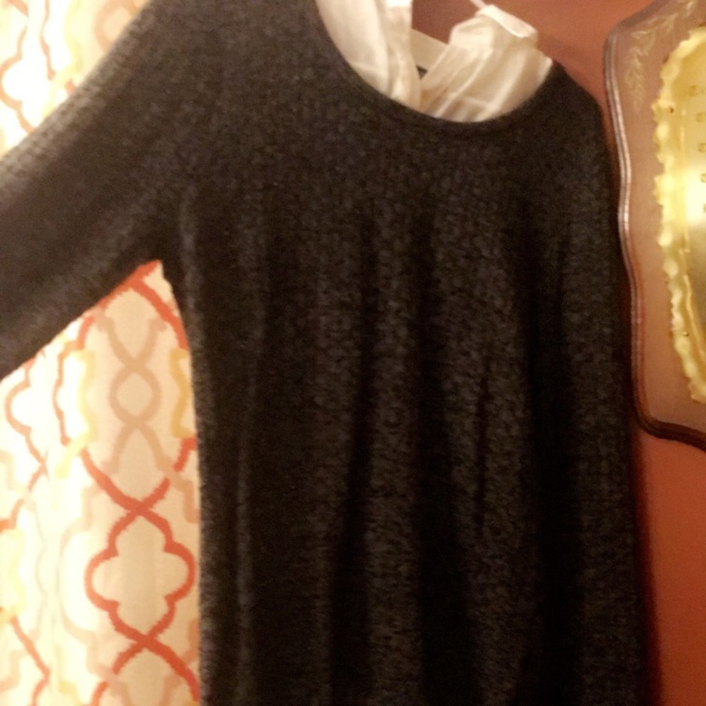 Grey sweater with a button down white shirt under